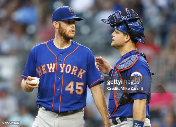 Pitcher Zack Wheeler of the New York Mets talks with catcher Devin Mesoraco in the third inning during the game against the Atlanta Braves at...