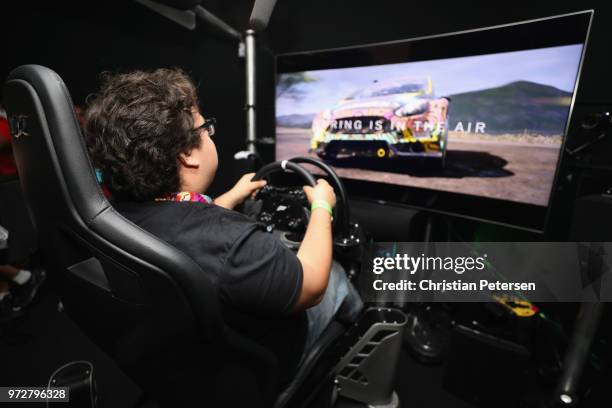 Game enthusiasts and industry personnel play 'Forza Horizon 4' during the Electronic Entertainment Expo E3 at the Microsoft Theater on June 12, 2018...