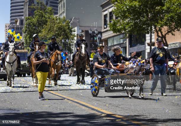 Oakland Police Chief Anne Kirkpatrick rides along the parade route in a carriage pulled by a pony during the Golden State Warriors NBA Championship...