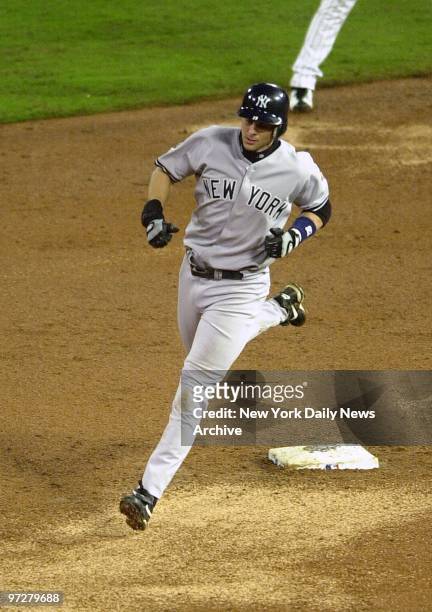 New York Yankees' Aaron Boone rounds the bases after hitting a solo home run in the ninth inning of Game 3 of the World Series against the Florida...