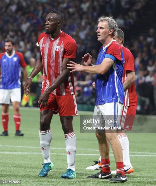 Usain Bolt of FIFA 98 in action with Laurent Blanc of France 98 during the Friendly match between France 98 and FIFA 98 at U Arena on June 12, 2018...