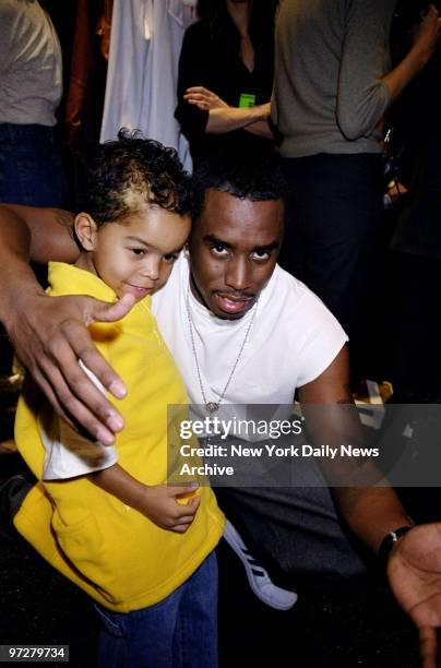 Sean Combs gives his son Justin a hug backstage at Combs' Sean John fashion show in Bryant Park.