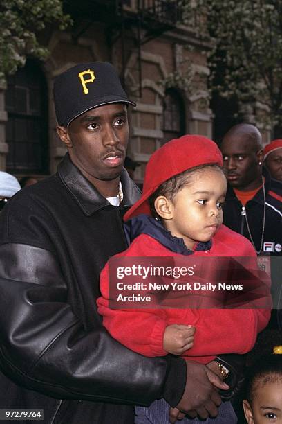 Sean Combs holds his son Justin on W. 122nd St., where Combs was directing the shooting of the music video "We'll Always Love You Big Poppa," a...