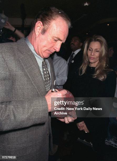 James Caan autographs football as his wife Linda looks on at benefit for the Hunter's Hope Foundation at the All-Star Cafe. The charity is named for...