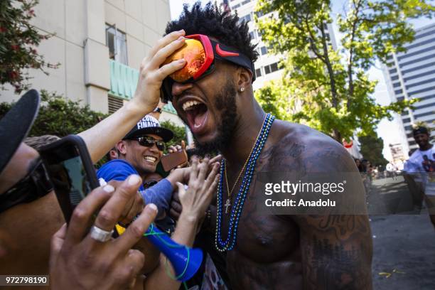 Jordan Bell of the Golden State Warriors interacts with fans during the Golden State Warriors NBA Championship Victory Parade in Oakland, California,...