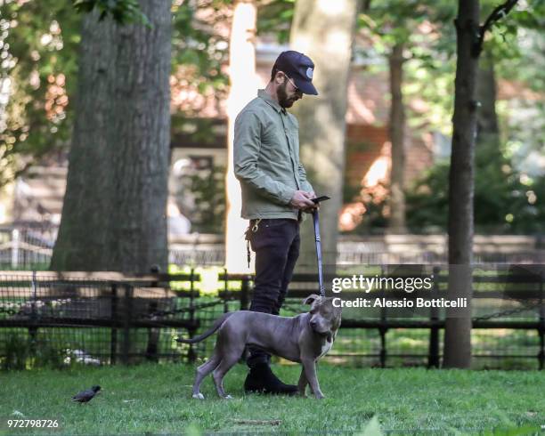 Justin Theroux is seen walking his new adopted rescue pit bull Kuma on June 12, 2018 in New York City.