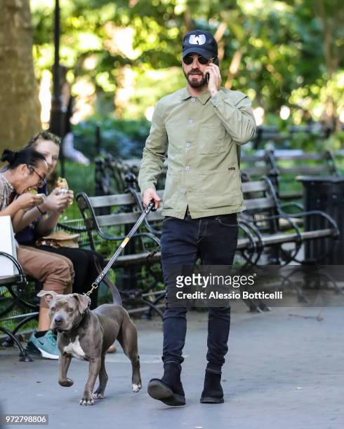 Justin Theroux is seen walking his new adopted rescue pit bull Kuma on June 12, 2018 in New York City.