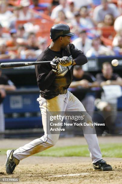 Florida Marlins' outfielder Juan Encarnacion is hit with a pitch and advances to first, scoring Juan Pierre in the ninth inning of game against the...