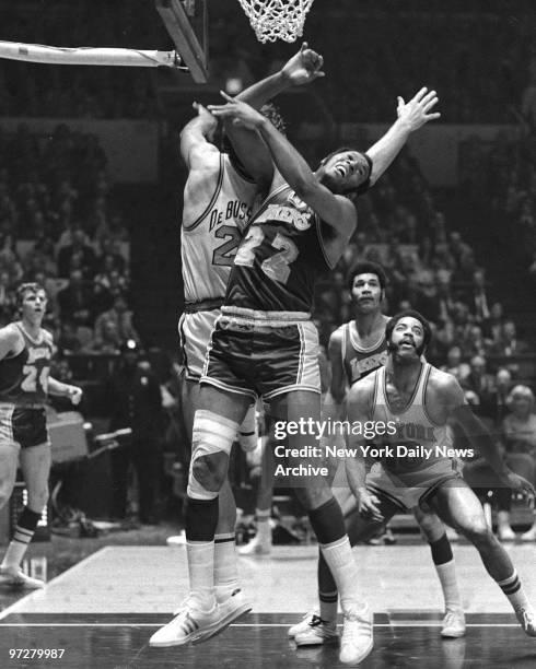 Los Angeles Lakers Elgin Baylor [22] battles N.Y. Knicks Dave DeBusschere for rebound as Knicks Walt Frazier [10] looks on during Game 7 of the...
