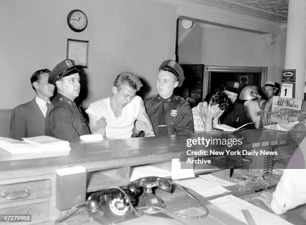 James Donovan whines as he is booked at the station house in Astoria for felonious assault. The seventeen-year-old, who was awaiting sentence for...