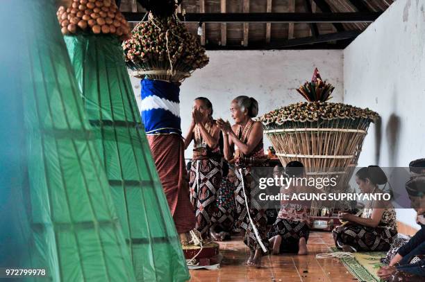 This picture taken on June 12, 2018 shows palace servants of the Sultan of Yogyakarta taking part in the Tumplak Wajik ceremony, to prepare the...