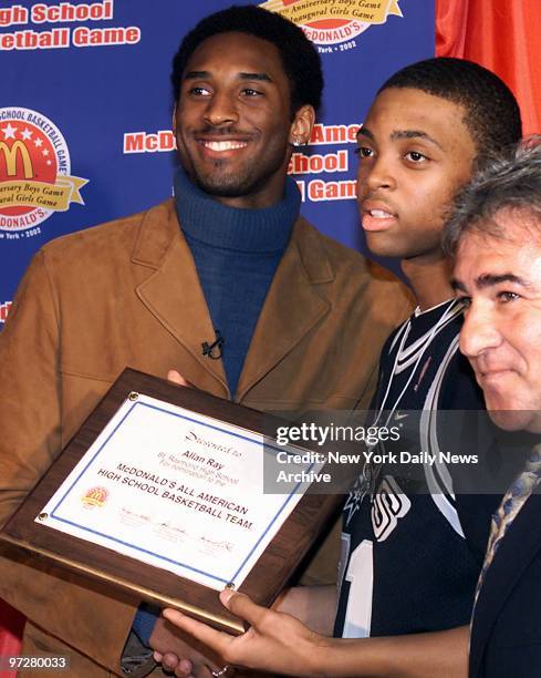 Los Angeles Lakers' Kobe Bryant presents a plaque to Allan Ray, a McDonald's All American High School Boys and Girls Basketball Game finalist from...