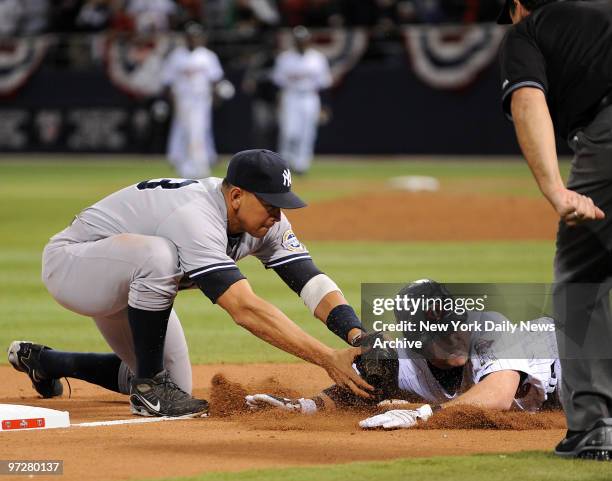 New York Yankees against the Minnesota Twins in Game 3 of the American League Division Series. Nick Punto can't get back to third base in time, as...