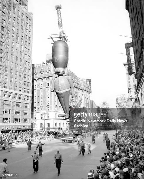 Crane carries balloon toy soldier down Broadway. The traditional figures in Macy's Thanksgiving Day parade used to float on helium, but government...