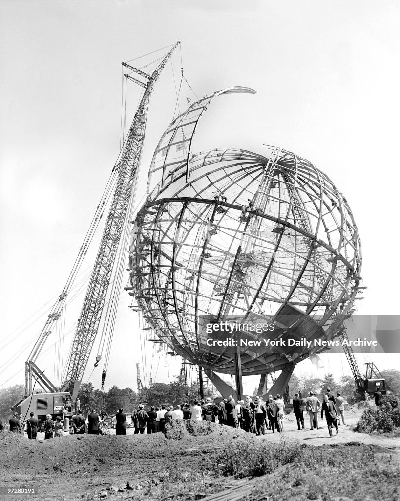 Crane eases last segment of the Unisphere into place to comp