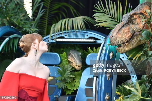 Actress Bryce Dallas Howard blows a kiss toward a dinosaur during the premiere of "Jurassic World: Fallen Kingdom" on June 12, 2018 at The Walt...
