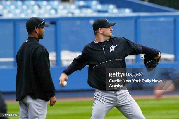 Florida Marlins' Ugueth Urbina and Brad Penny warm up their pitching arms during practice at Yankee Stadium on the day before they take on the New...