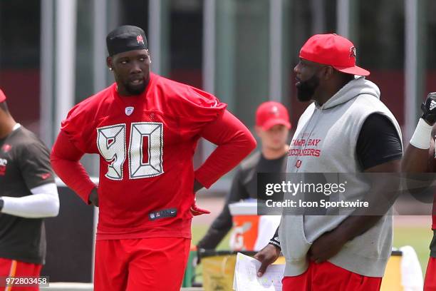 Jason Pierre-Paul talks with defensive line coach Brentson Buckner during the Tampa Bay Buccaneers Minicamp on June 12, 2018 at One Buccaneer Place...