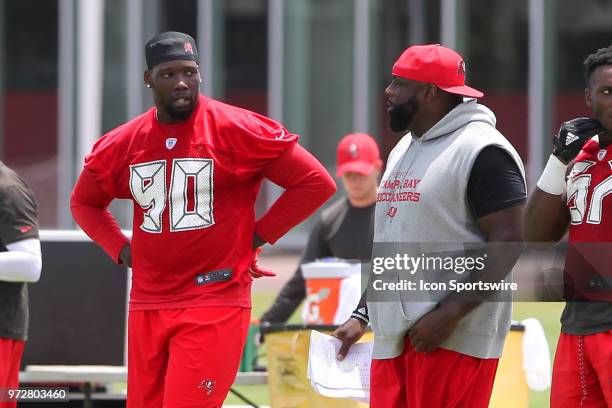 Jason Pierre-Paul talks with defensive line coach Brentson Buckner during the Tampa Bay Buccaneers Minicamp on June 12, 2018 at One Buccaneer Place...