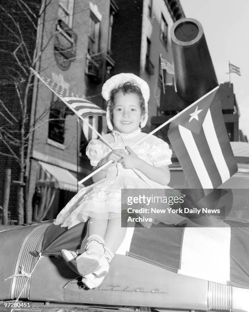 The Love a Parade. Luz Valentin has the spirit as she waves American and Puerto Rican flags from hood of a car in which she rode in Puerto Rican Day...