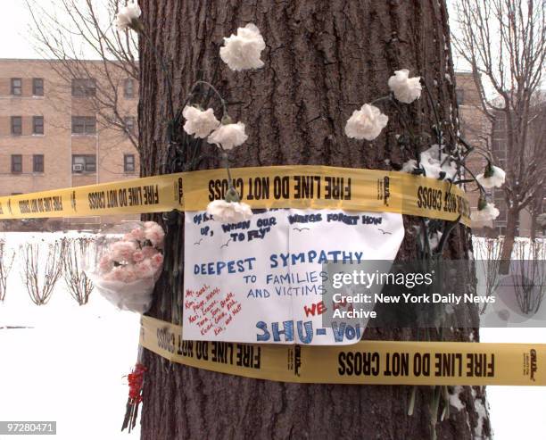 Flowers and a memorial message have been placed on tree near dormitory on the Seton Hall University campus where blaze killed three students and...