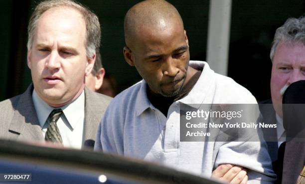 Sean Sally is escorted to a waiting car at Kennedy Airport after a flight from Miami, where he was arrested. Salley was later indicted on second...