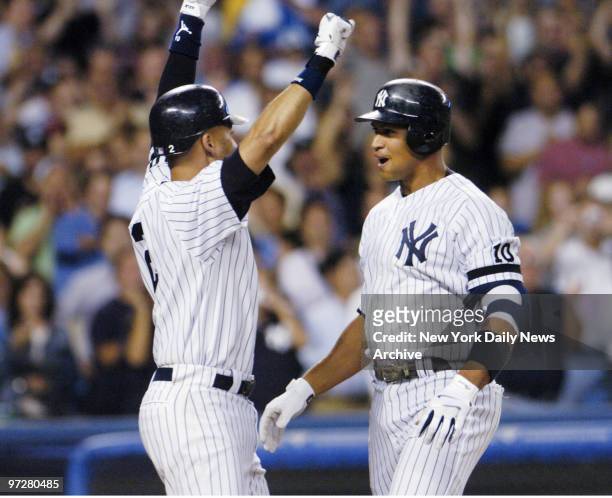 New York Yankees' Alex Rodriguez is greeted at the plate by teammate Derek Jeter after they scored on Rodriguez's two-run homer in the seventh inning...