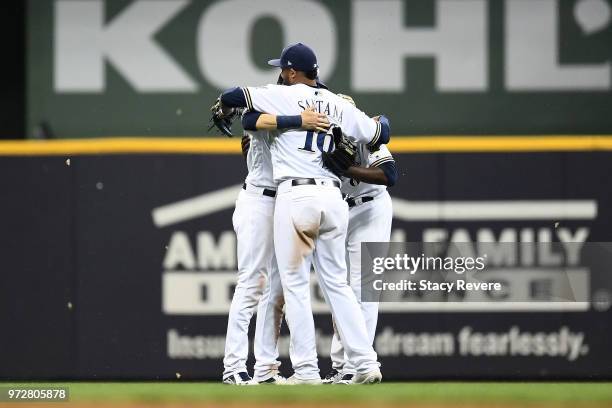 Domingo Santana of the Milwaukee Brewers celebrates with teammates following a victory over the Chicago Cubs at Miller Park on June 12, 2018 in...