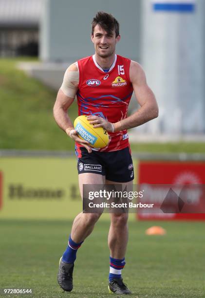 Tom Campbell of the Bulldogs runs with the ball during a Western Bulldogs AFL training session at Whitten Oval on June 13, 2018 in Melbourne,...