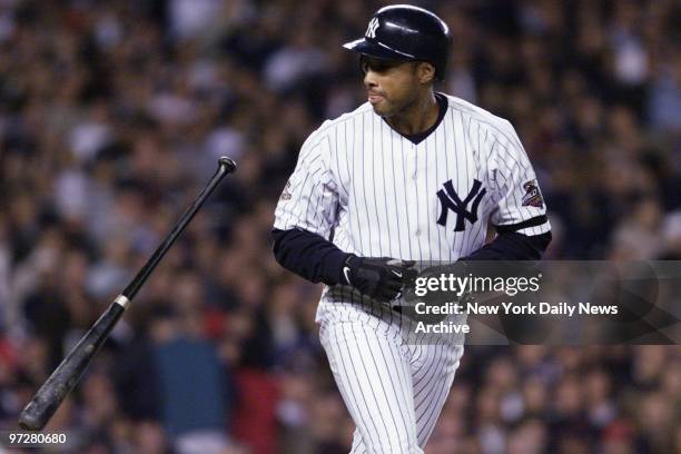 New York Yankees' Bernie Williams drops his bat as he heads to first after drawing a walk in the fourth inning of Game 5 of the World Series. The...