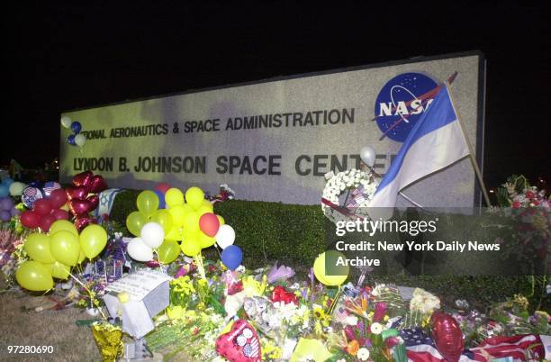 Flowers, flags and balloons form a makeshift memorial at the entrance to the Johnson Space Center in Houston to the seven astronauts who died...