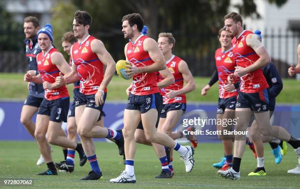 Tom Campbell of the Bulldogs and Kieran Collins of the Bulldogs run during a Western Bulldogs AFL training session at Whitten Oval on June 13, 2018...