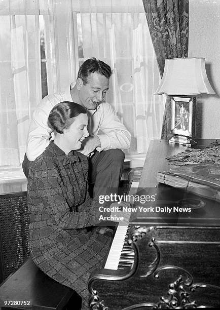 Lou Gehrig sings while his wife plays the piano at their New Rochelle home.