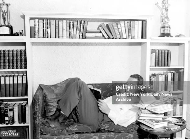 Lou Gehrig, Yankee first baseman, takes it easy in his New Rochelle home as his teammates work out in Florida sun. He doesn't seem too worry over his...