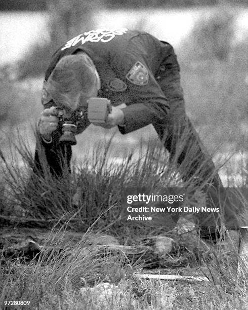 Crime scene photographer takes photos of remains of one of the victims of the serial killer, Joel RIfkin.