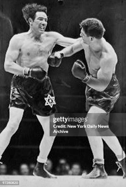 Lou Nova lands a right punch to the stomach of Max Baer during their fight on June 1, 1939 at Yankee Stadium in the Bronx, New York.