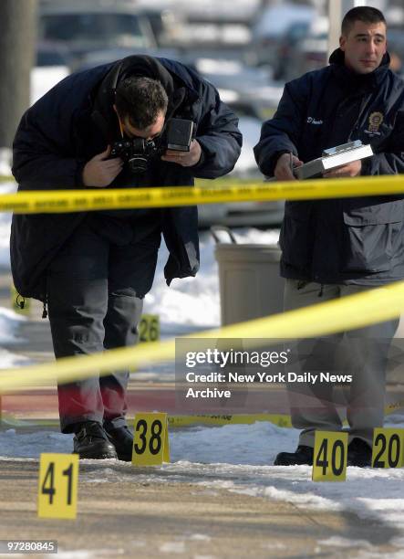 Crime Scene Unit officers photograph evidence at the scene on Arnow Place near Westchester Ave. In Pelham Bay, the Bronx, where Police Officer Daniel...