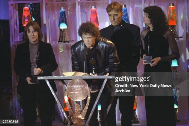 Maureen Tucker , Lou Reed and John Cale of the group Velvet Underground accept an award at the Rock 'n' Roll Hall of Fame induction ceremonies at the...