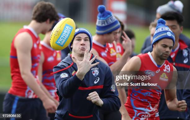 Billy Gowers of the Bulldogs runs with the ball during a Western Bulldogs AFL training session at Whitten Oval on June 13, 2018 in Melbourne,...