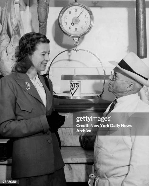 American socialite Mary Benedict Cushing , wife of Vincent Astor, shows how you turn in a pound of salvaged fats and receive two ration stamps.