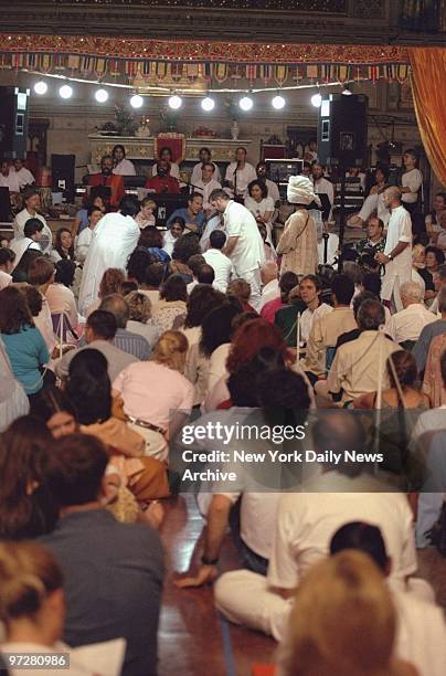 Followers and admirers sit on floor as Indian spiritual teacher Mata Amritanandamayi greets visitors at the Fourth Universalist Society on Central...