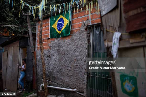 Residents of the neighborhood of Jardim Peri adorn the streets and prepare to watch the 2018 World Cup taking place in Russia on June 12, 2018 in Sao...