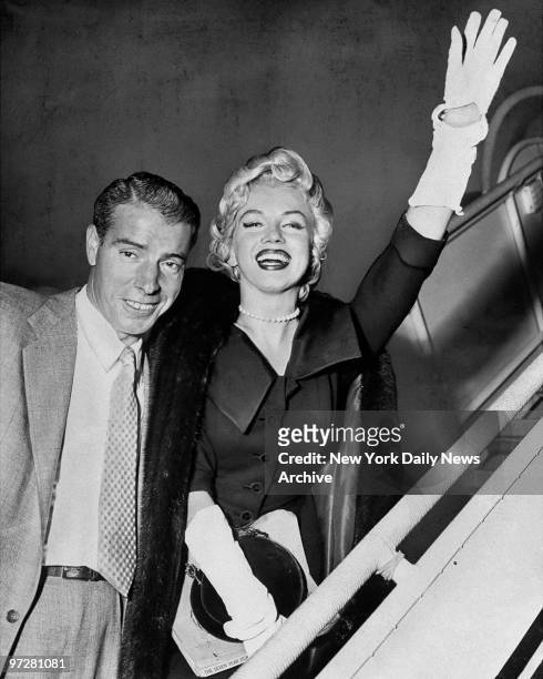 Joe DiMaggio and Marilyn Monroe as they board plane at International Airport.