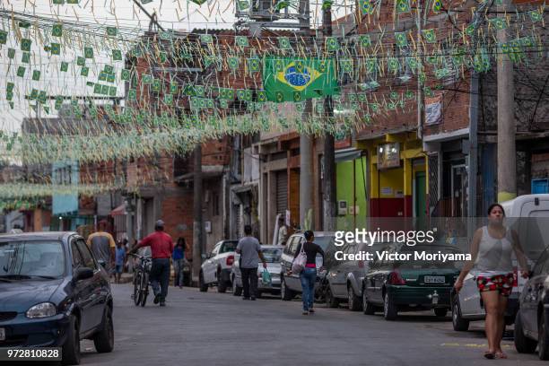 Residents of the neighborhood of Jardim Peri adorn the streets and prepare to watch the 2018 World Cup taking place in Russia. Brazil plays to be the...