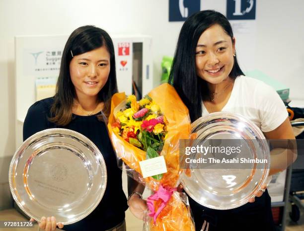 Eri Hozumi and Makoto Ninomiya pose for photographs on arrival at Haneda Airport on June 12, 2018 in Tokyo, Japan.