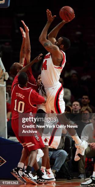 Louisville Cardinals' Brian Johnson shoots over South Carolina Gamecocks' Rocky Trice during a semifinal of the 2006 National Invitational Tournament...