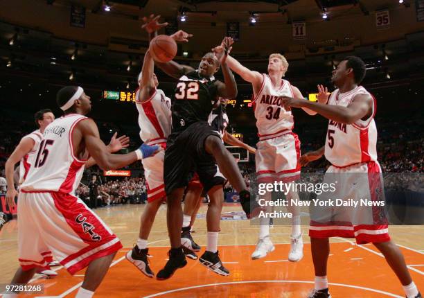 Louisville Cardinals' Derrick Caracter battles for a rebound during the first half of Game 2 of the Jimmy V Classic against the Arizona Wildcats at...