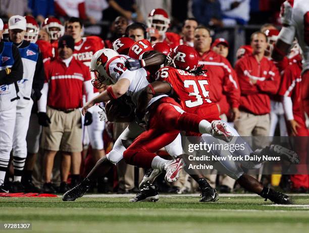 Louisville Cardinals' quarterback Brian Brohm is taken down by Rutgers Scarlet Knights during a game at Rutgers Stadium. The 15th-ranked Scarlet...