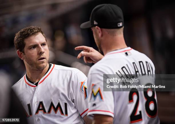 Shuck talks with Bryan Holaday of the Miami Marlins during the game against the San Francisco Giants at Marlins Park on June 12, 2018 in Miami,...