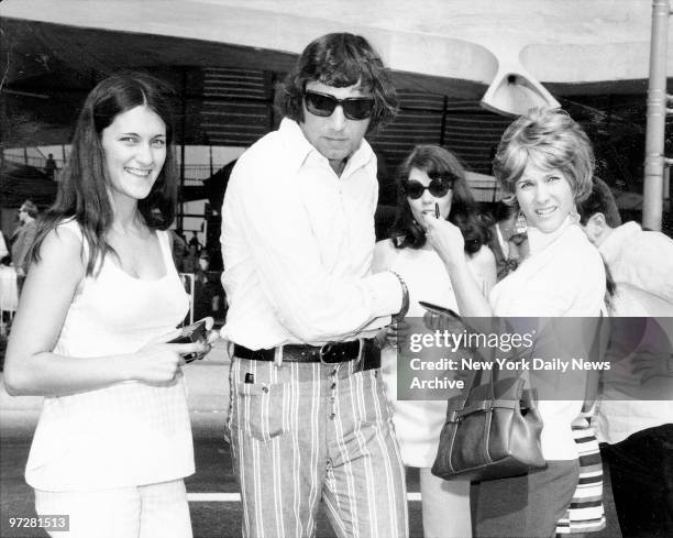 Football star Joe Namath arriving at JFK airport as he meets some of his more shapely admirers.